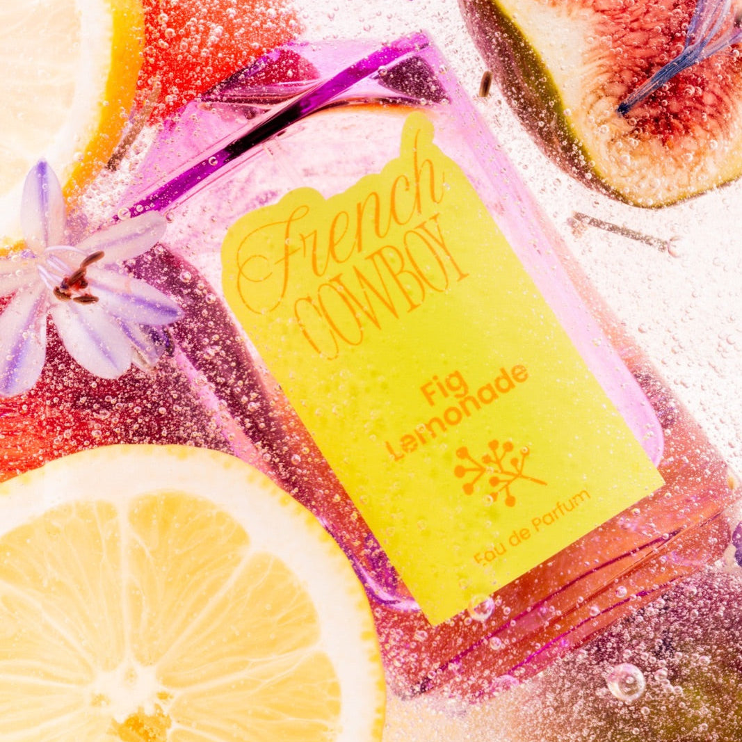 French Cowboy Fig Lemonade bottle surrounded by lemon slices and figs